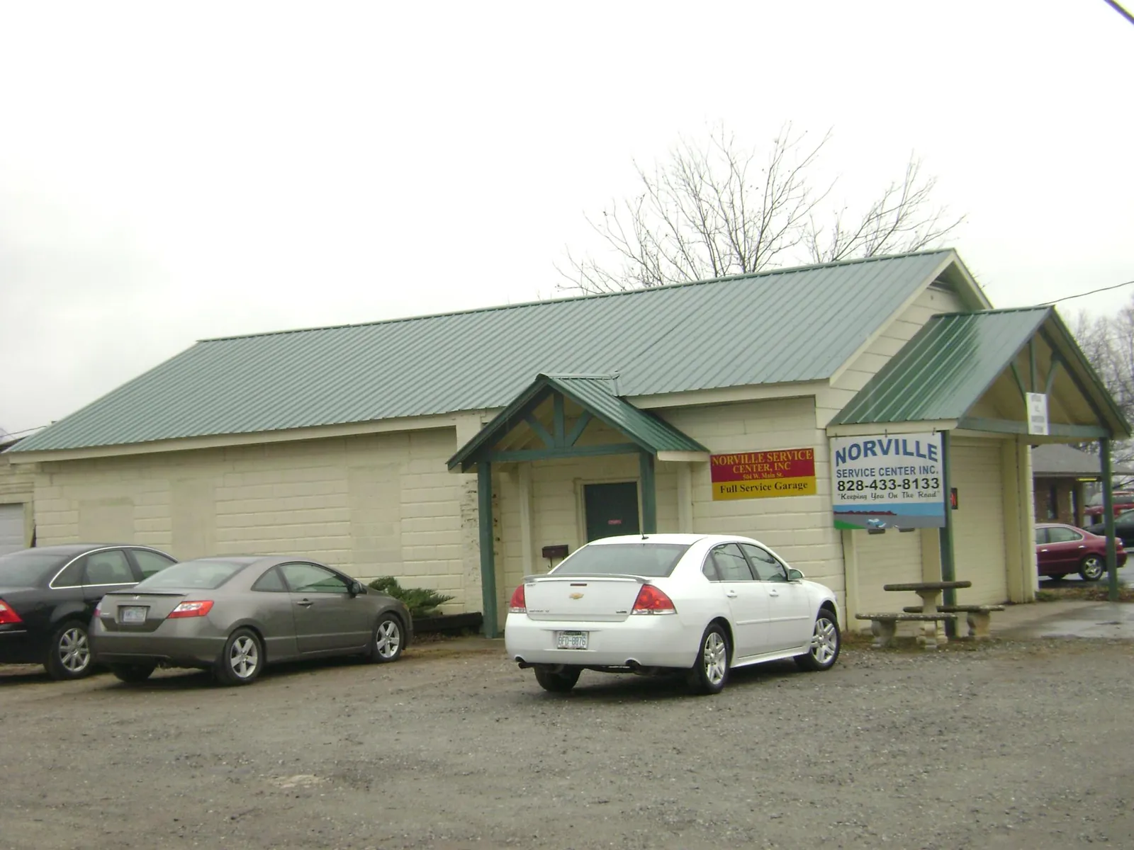 Green metal roof on a service garage with a covered entry in Oxford